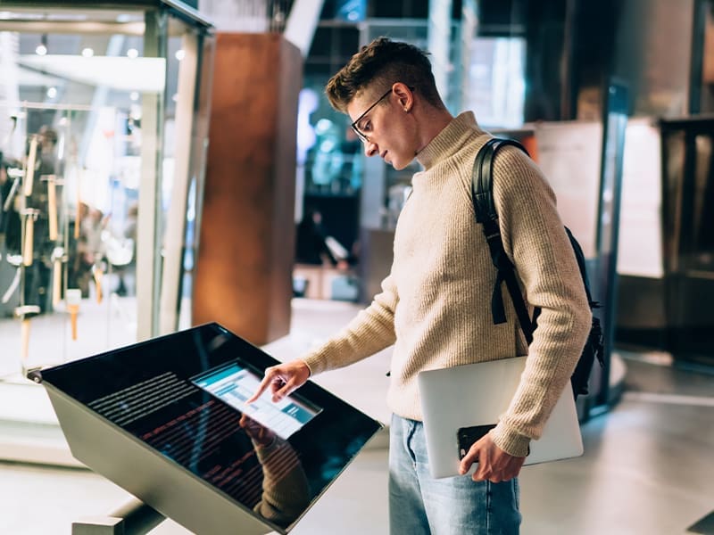 man standing in front of a display of electronic devices